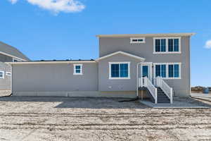 Back of property featuring stucco siding