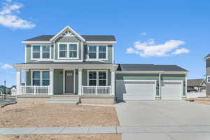 View of front of house with board and batten siding, roof with shingles, a porch, a garage, and concrete driveway