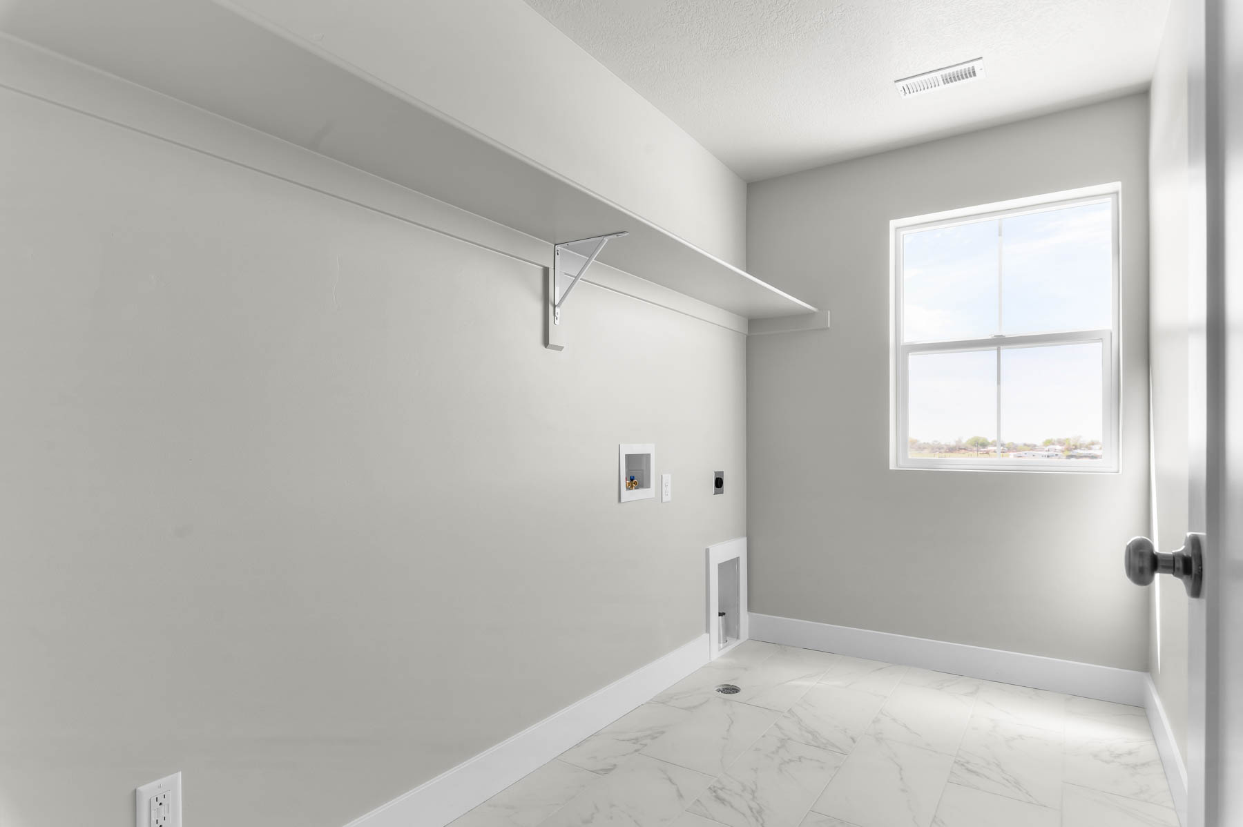Laundry room with light marble finish floors, electric dryer hookup, and washer hookup