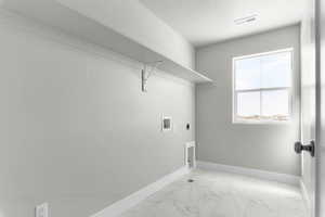 Laundry room with light marble finish floors, electric dryer hookup, and washer hookup