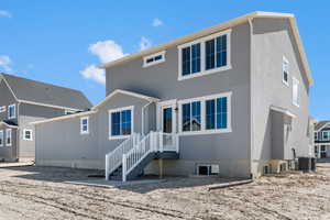 Rear view of property featuring stucco siding