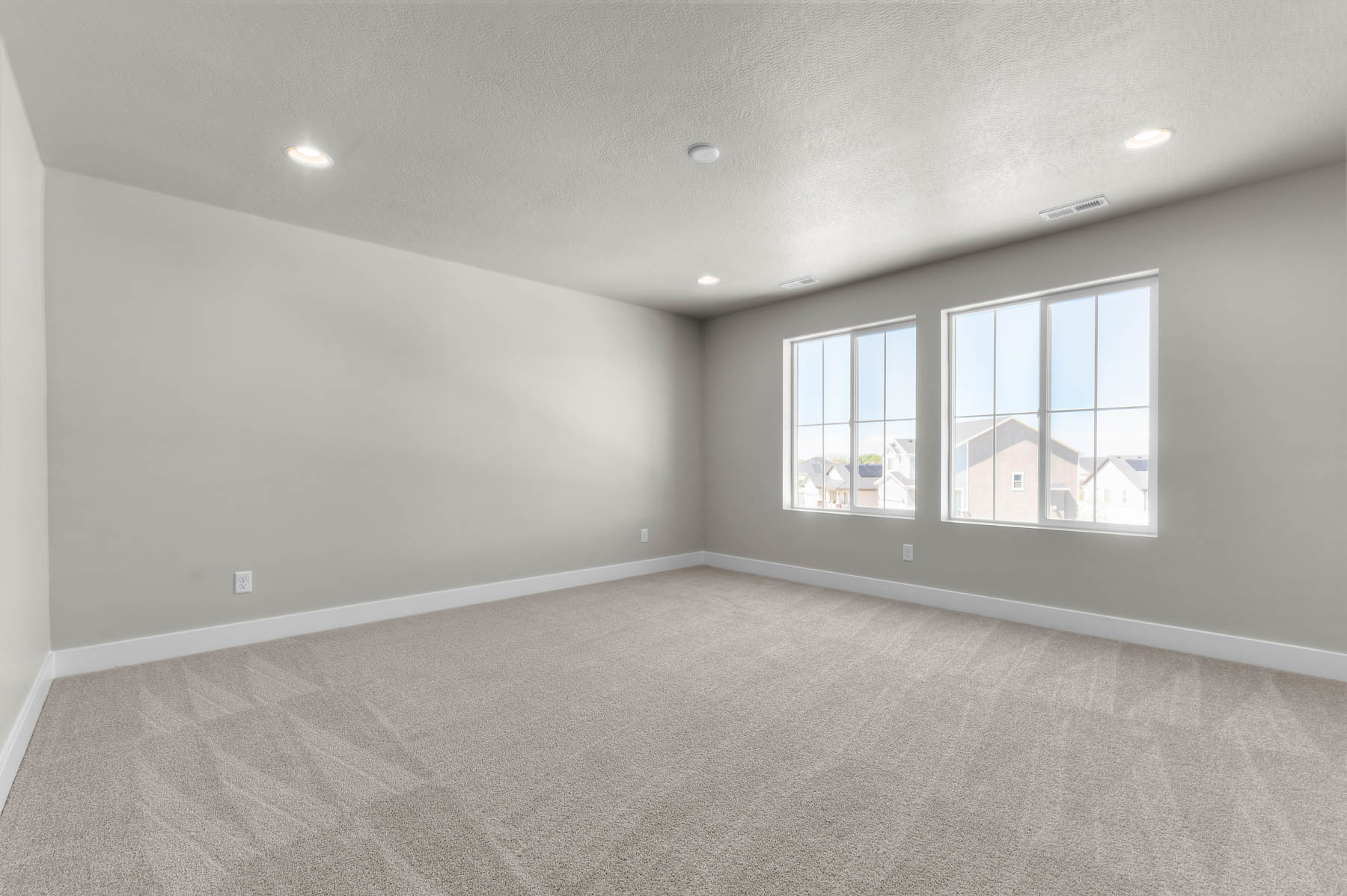 Empty room featuring light carpet, recessed lighting, and a textured ceiling