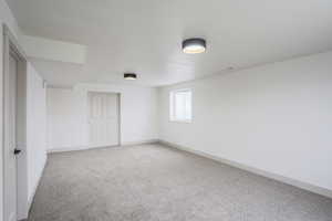 Unfurnished bedroom with light colored carpet and a closet