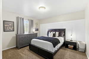 Carpeted bedroom featuring baseboards