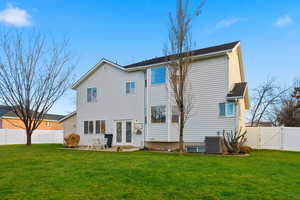 Back of house with a fenced backyard, a patio area, and a gate