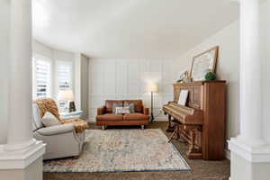 Living room with ornate columns and carpet