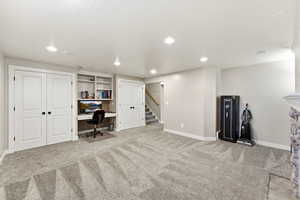 Carpeted office space with recessed lighting