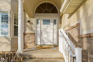 Property entrance with stucco siding and brick siding