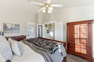 Bedroom featuring carpet floors, ceiling fan, and high vaulted ceiling