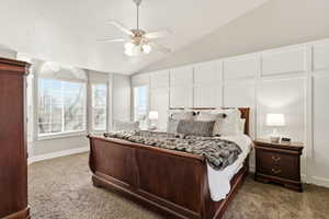 Bedroom with lofted ceiling, carpet flooring, and ceiling fan