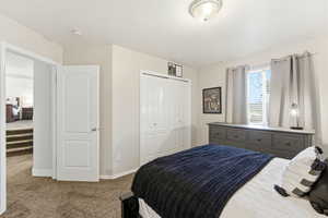 Bedroom with carpet floors and a closet