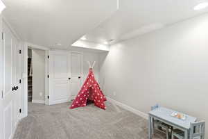 Recreation room with recessed lighting and carpet