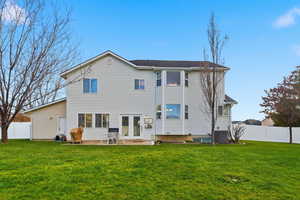 Back of house featuring a fenced backyard and a patio