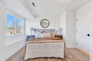 Carpeted bedroom featuring baseboards
