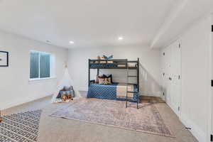 Carpeted bedroom with baseboards and recessed lighting