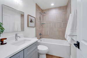 Bathroom with vanity and shower / washtub combination