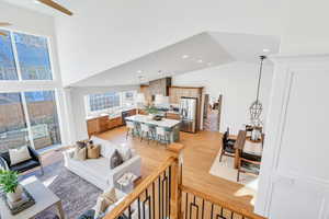 Living area featuring recessed lighting, light wood-style floors, ceiling fan, and high vaulted ceiling
