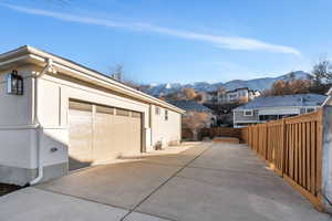Garage with a mountain view and concrete driveway