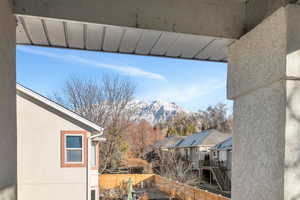 Detailed view of a fenced backyard, stucco siding, and stairs