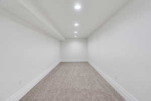 Empty room featuring light colored carpet and recessed lighting