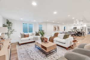 Living room featuring light wood-style flooring and recessed lighting