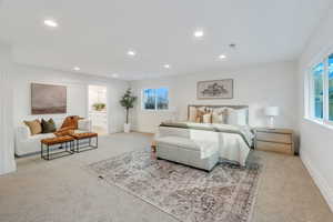 Bedroom with light carpet, recessed lighting, and ensuite bath