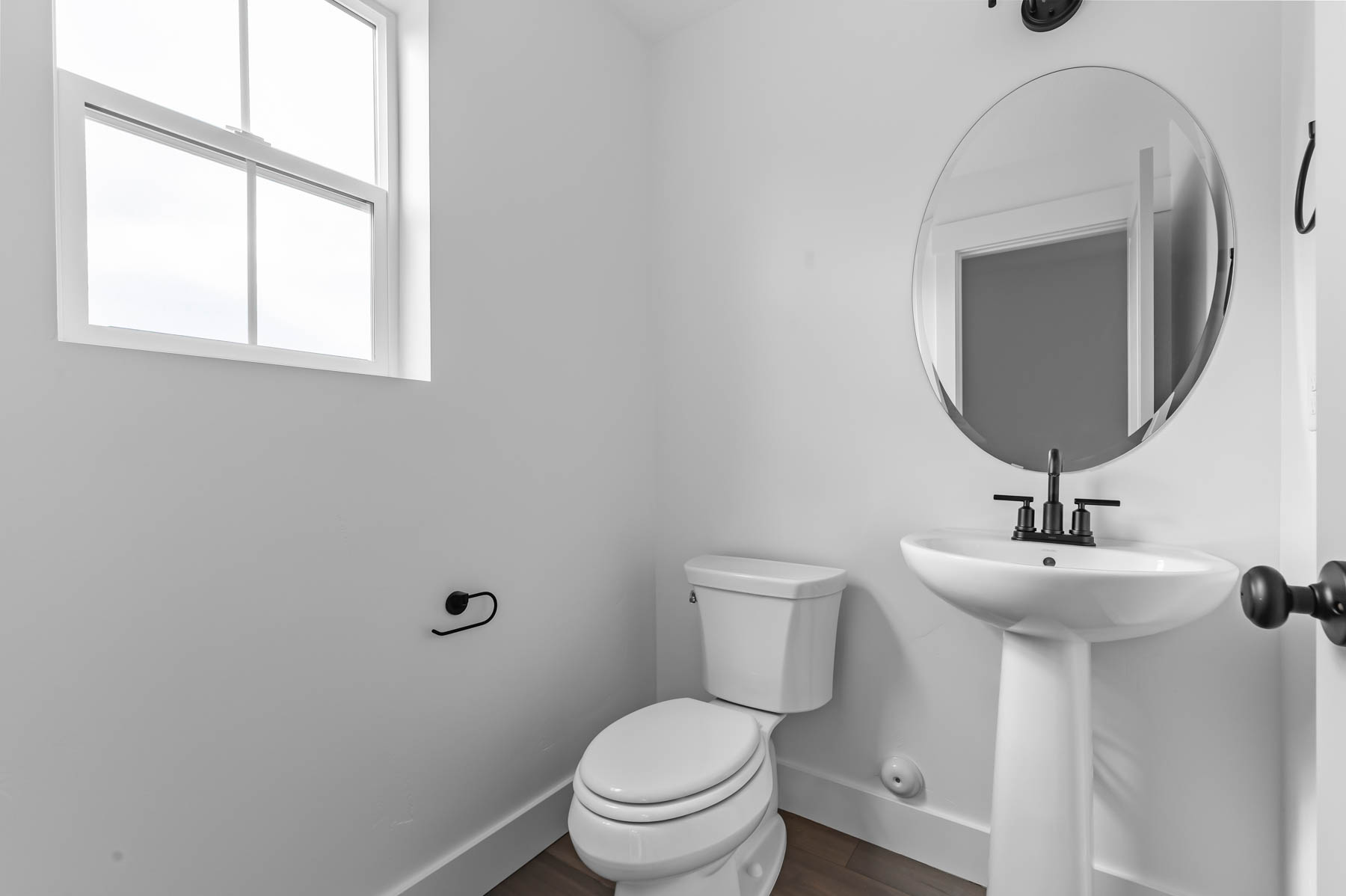 Bathroom with toilet and dark wood finished floors