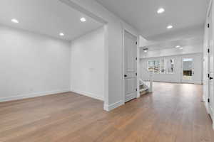 Corridor with recessed lighting and light wood-style flooring