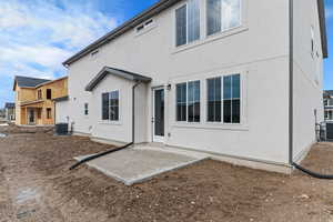 Back of property with a patio area and stucco siding