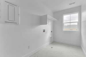 Laundry area featuring light marble finish floors, electric dryer hookup, and washer hookup
