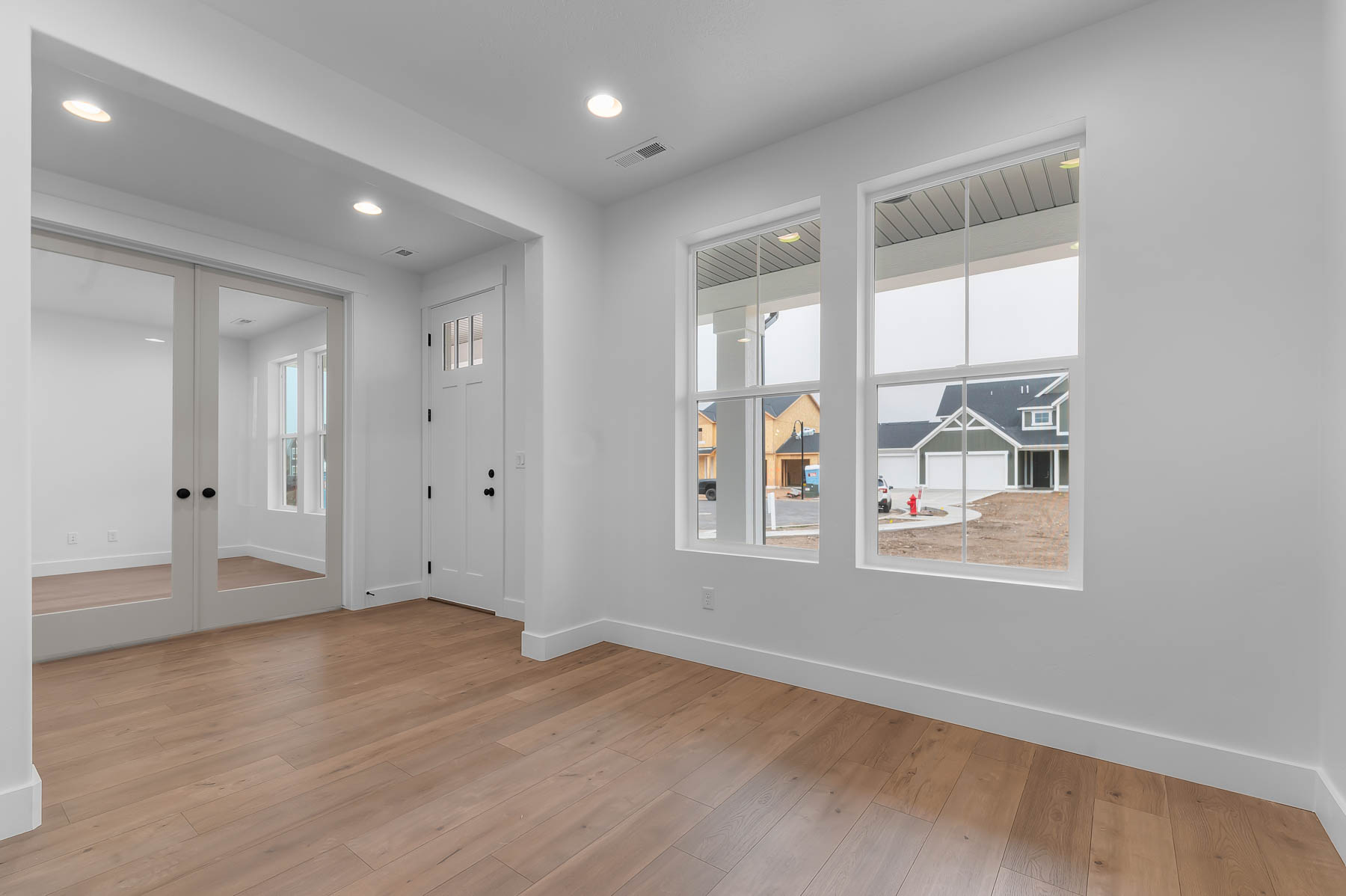 Entrance foyer featuring light wood-style floors, recessed lighting, and french doors