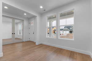 Entrance foyer featuring light wood-style floors, recessed lighting, and french doors