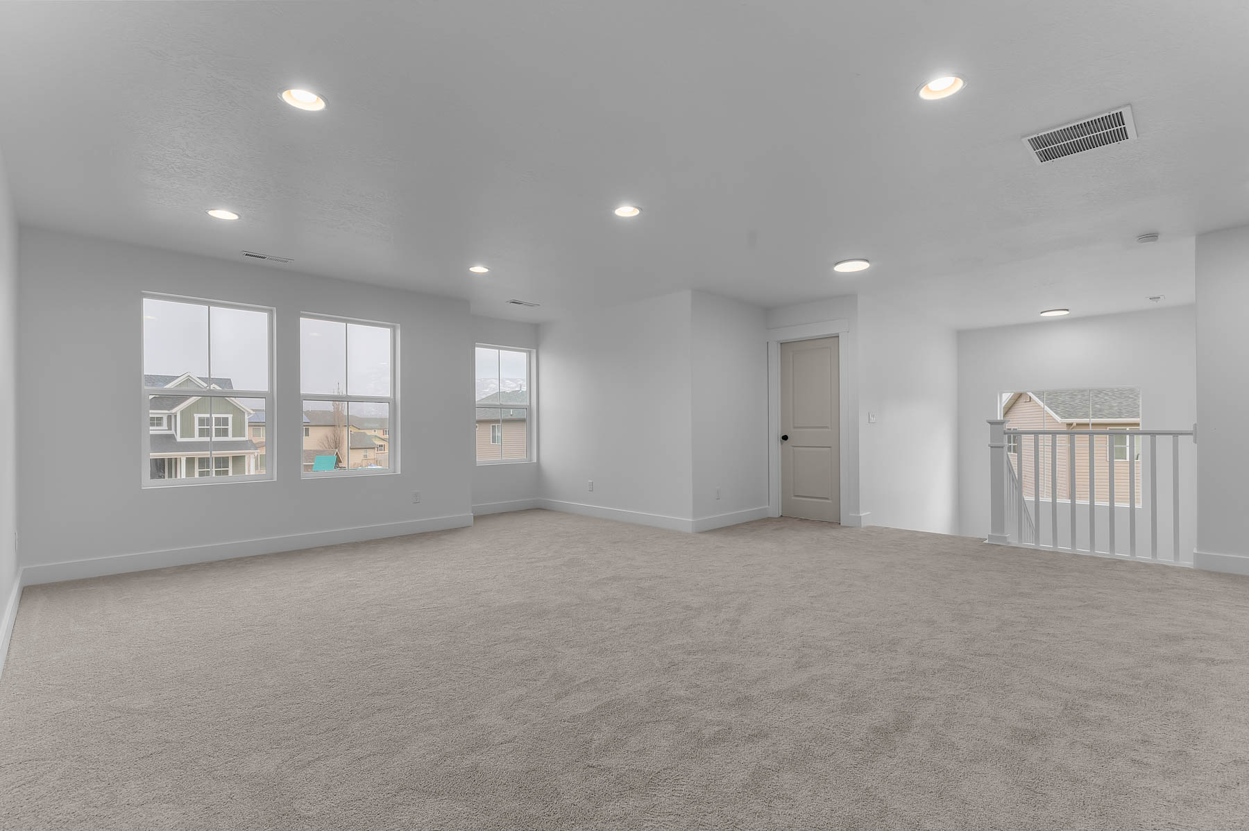 Spare room featuring light colored carpet and recessed lighting