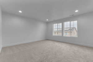 Unfurnished room featuring light carpet and recessed lighting