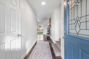 Foyer entrance featuring baseboards and a fireplace