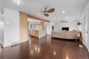 Living area featuring recessed lighting, dark wood-style flooring, and a ceiling fan