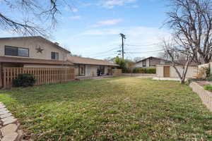 Fenced backyard featuring a patio area and an outdoor structure