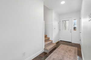 Entryway featuring stone tile floors and stairs