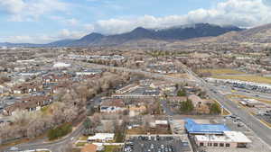 Aerial view of property and surrounding area with a mountain backdrop