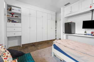 Bedroom featuring stone finish floors and a closet