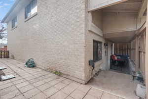 View of home's exterior featuring brick siding and a patio