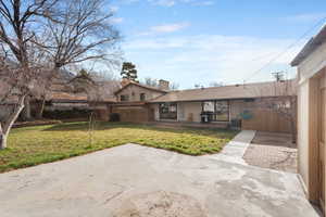 Rear view of house with a patio and a chimney
