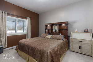 Bedroom featuring light carpet