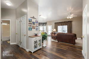 Living room with dark wood finished floors and ceiling fan