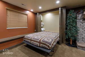 Carpeted bedroom with recessed lighting