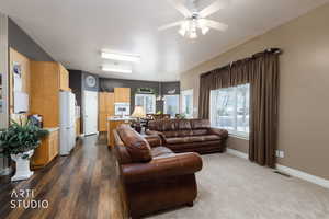 Living area featuring baseboards and a ceiling fan