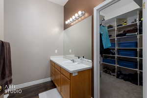 Bathroom with vanity and a spacious closet