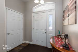 Foyer entrance with dark wood-style floors