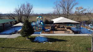 View of property's community with a yard and a patio area