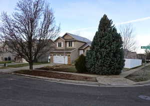Traditional-style home with driveway and a garage